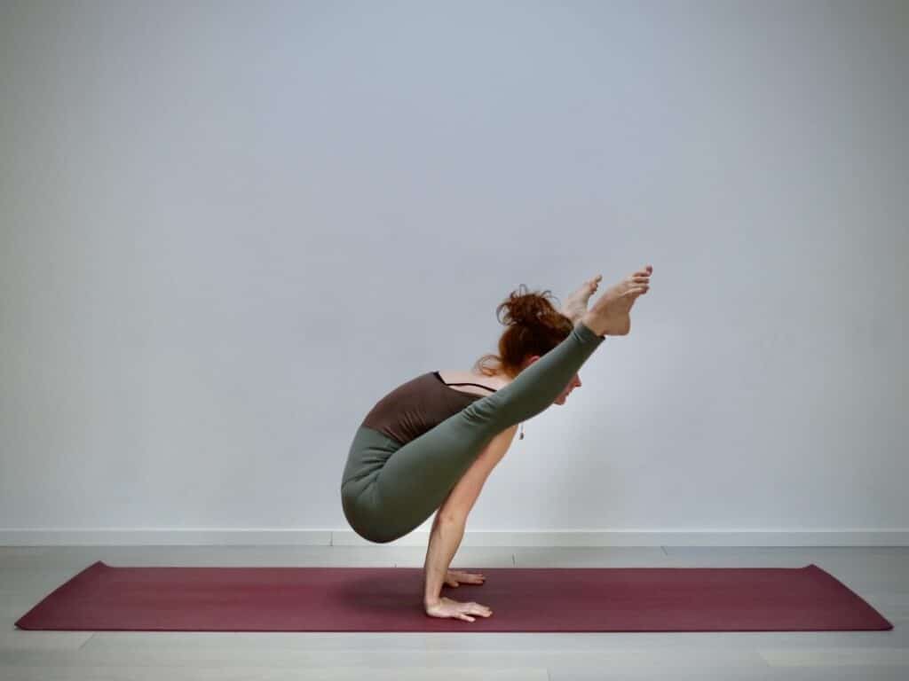 Helen, yoga teacher, doing firefly pose